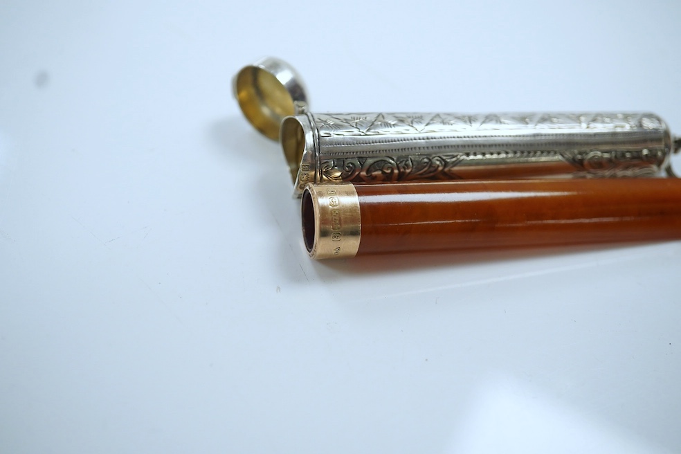 A 9ct gold mounted amber cigarette holder, 78mm, in a silver case. Condition - fair